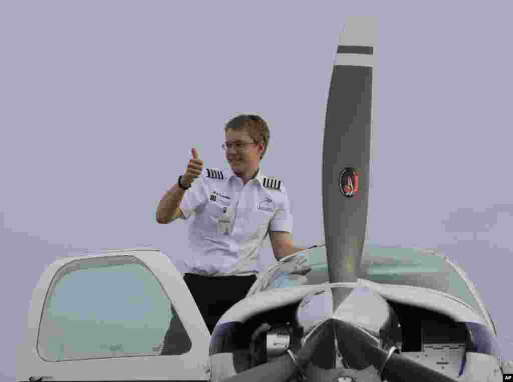 Matt Guthmiller, from Aberdeen, South Dakota, flashes a thumbs-up sign from his single-engine plane after landing at the Manila International Airport, Philippilippines.&nbsp; Guthmiller, 17, is attempting to be the youngest pilot to fly solo around the world.&nbsp; He has eight more legs to complete his feat with Darwin, Australia, as his next stop.