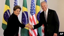 U.S. Vice President Joe Biden, right, shakes hands with Brazil’s President Dilma Rousseff.