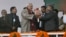 Indian Prime Minister Narendra Modi, center, is given flowers as he arrives for a campaign rally ahead of local elections in Srinagar, in Indian-controlled Kashmir, Dec. 8, 2014. 