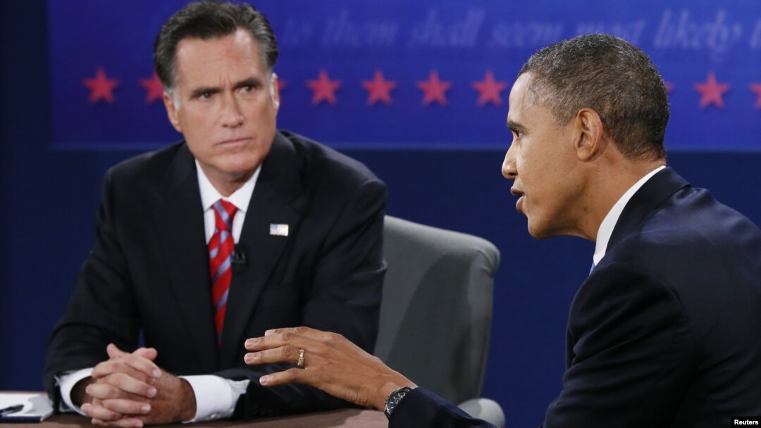 U.S. President Barack Obama speaks as Republican presidential nominee Mitt Romney listens during the final U.S. presidential debate in Boca Raton, Florida, October 22, 2012. 