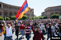Armenian opposition supporters walk on the street after protest movement leader Nikol Pashinyan announced a nationwide campaign of civil disobedience in Yerevan, Armenia, May 2, 2018. The protests eventually forced the resignation of Armenia’s longtime leader blamed for incompetence and corruption.