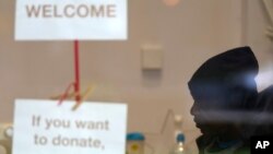 Dave sits at the Community Food Hub in London. He is one of a large number of people who do not have enough to eat across Great Britain. (AP Photo/Frank Augstein)