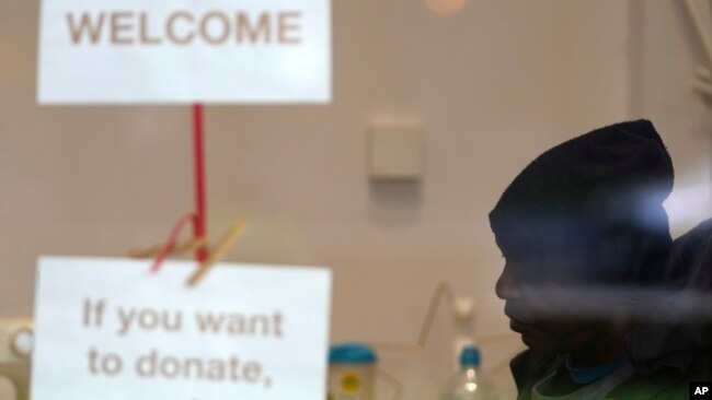 Dave sits at the Community Food Hub in London. He is one of a large number of people who do not have enough to eat across Great Britain. (AP Photo/Frank Augstein)