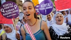 Demonstrators shout slogans, march with placards to protest the government's plans on a new abortion law, Istanbul, June 17, 2012.