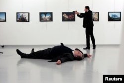 Russian Ambassador to Turkey Andrei Karlov lies on the ground after he was shot by Mevlut Mert Altintas at an art gallery in Ankara, Turkey, Dec. 19, 2016.