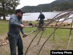 Iraq War veteran Michael Carroll, assisting in building the frame for a sweat lodge under the direction of Blackfeet Indian cultural advisors. Courtesy: Michael Carroll.