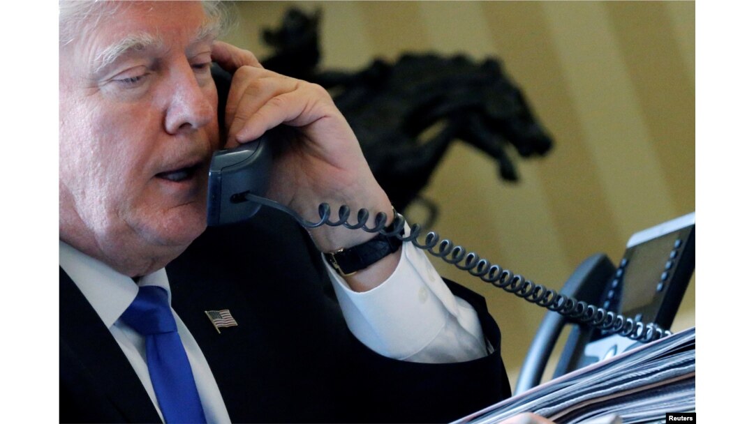 U.S. President Donald Trump speaks by phone with Russia's President Vladimir Putin in the Oval Office at the White House in Washington, Jan. 28, 2017.