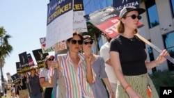 Actors Aubrey Plaza, left, and Hannah Einbinder, right, picket outside Netflix studios on July 20, 2023, in Los Angeles, California. The actors strike comes more than two months after screenwriters began striking for better pay and working conditions. (AP Photo/Chris Pizzello)