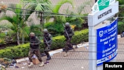 Kenya Defense Force soldiers run to take their positions at the Westgate shopping mall on the fourth day since militants stormed into the mall, in Nairobi, Sept. 24, 2013. 