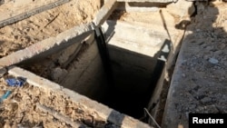 An Israeli soldier shows a Hamas tunnel shaft near a school in a location given as Beit Lahiya, Gaza, by Israel Defense Forces, on Dec. 2, 2023. (Israel Defense Forces vis Reuters)