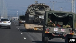 An Israeli army convoy advances on a northern road near the border with Lebanon on Oct. 17, 2023.