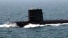 FILE - Chinese sailors salute on top of a submarine during the fleet's review of the China-Russia joint naval exercise in the Yellow Sea.