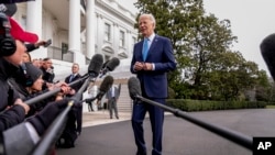 FILE—President Joe Biden speaks tomembers of the media before boarding Marine One on the South Lawn of the White House in Washington, January 30, 2024. 