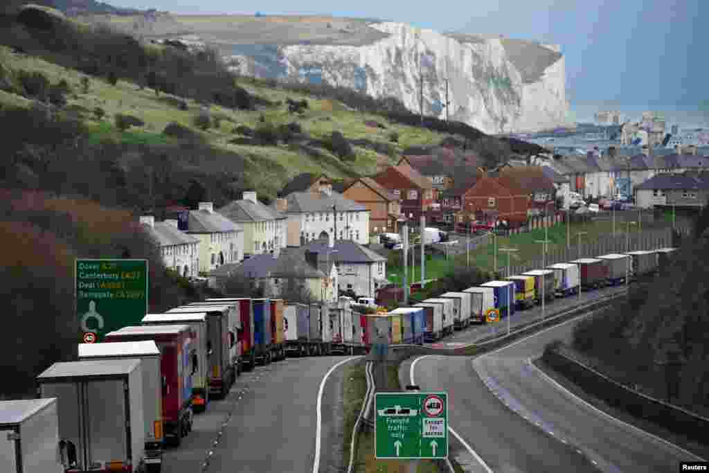 Trucks queue on A20 to enter the Port of Dover to board ferries to Europe, in Dover, Britain, Dec. 12, 2020.