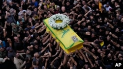 Hezbollah members transportation  the coffin of their comrade who was killed erstwhile   a handheld instrumentality  exploded, during a ceremonial   procession successful  the confederate  suburbs of Beirut, Sept. 19, 2024.