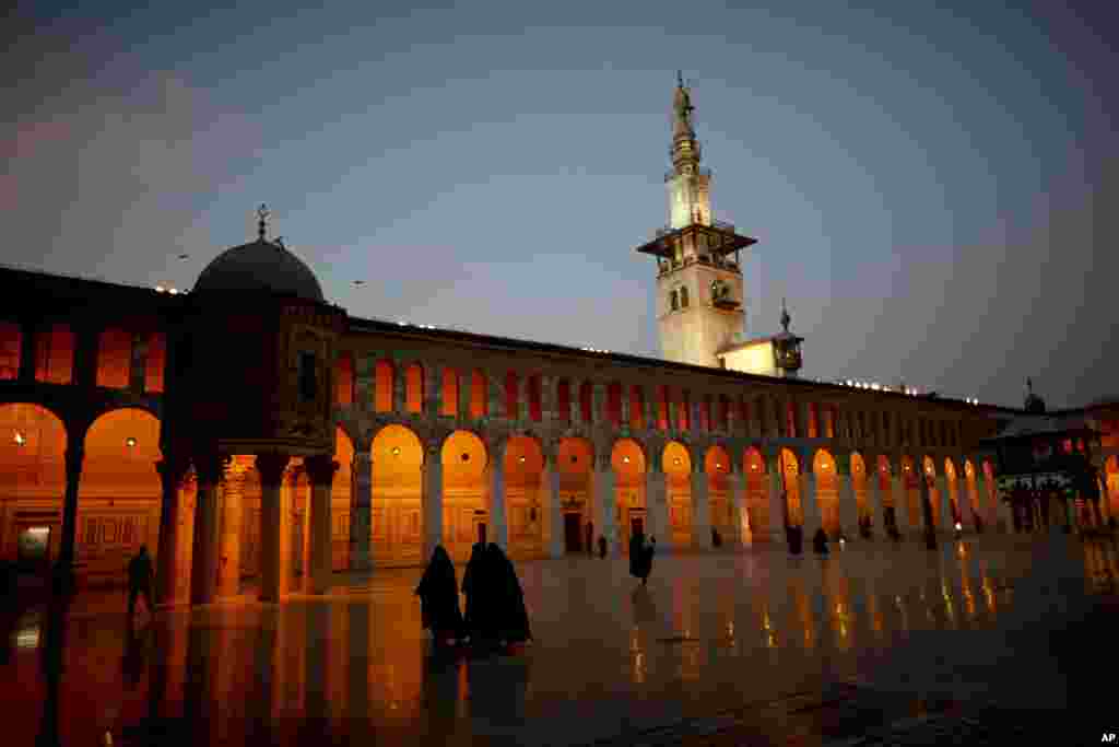 Muslim women walk in the courtyard of the 7th century Umayyad Mosque in Damascus, Syria.