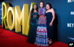 FILE - Mexican actresses who star in the Mexican film "Roma," Yalitza Aparicio, from left, Marina de Tavira and Nancy Garcia, pose on the red carpet in Mexico City, Nov. 21, 2018.