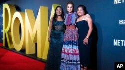 FILE - Mexican actresses who star in the Mexican film "Roma," Yalitza Aparicio, from left, Marina de Tavira and Nancy Garcia, pose on the red carpet in Mexico City, Nov. 21, 2018.