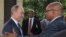 Russian President Vladimir Putin, left, and South African President Jacob Zuma shake hands at the BRICS summit in Durban, South Africa, March 27, 2013.