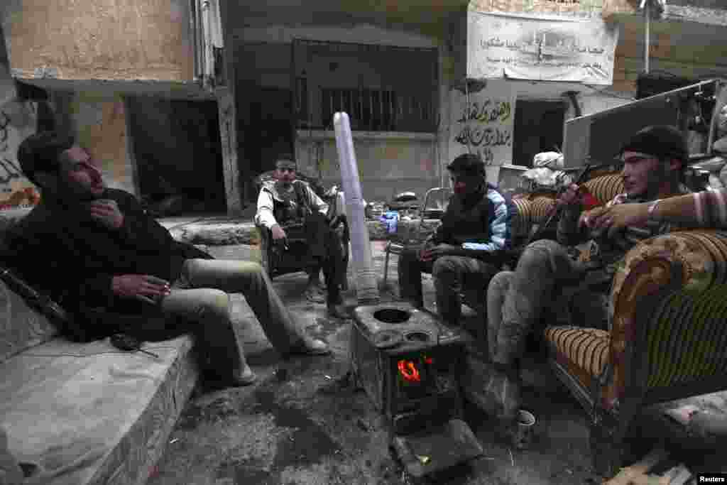 Free Syrian Army fighters sit together as they rest in Deir al-Zor, Nov. 25, 2013.