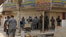 Iraqi security forces inspect the scene of a robbery in New Baghdad, Iraq, Thursday, Aug. 5, 2010. Gunmen stormed a Baghdad money exchange and killed three people, the latest in recent brash daylight attacks on banks, financial and trade centers in the Ir