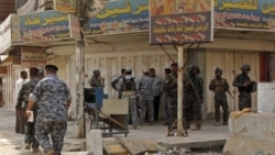 Iraqi security forces inspect the scene of a robbery in New Baghdad, Iraq, Thursday, Aug. 5, 2010. Gunmen stormed a Baghdad money exchange and killed three people, the latest in recent brash daylight attacks on banks, financial and trade centers in the Ir