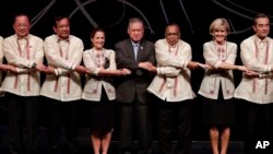 From left, North Korea's Foreign Minister Ri Yong Ho, Cambodia's Foreign Minister Prak Sokhonn, Canada's Foreign Minister Chrystia Freeland, Brunei Foreign Minister Lim Jock Seng, Bangladesh's Foreign Minister Abul Hassan Mahmood Ali, Australia's Foreign Minister Julie Bishop and China's Foreign Minister Wang Yi link arms during the Gala Dinner of the Association of Southeast Asian Nations (ASEAN) Foreign Ministers' Meeting (AMM) and Related Meetings in suburban Pasay city, southeast of Manila, Philippines Sunday, Aug. 6, 2017. (Mark Cristino/Pool Photo via AP)