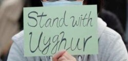 A man holds a sign during a rally to show support for Uighurs and their fight for human rights in Hong Kong, Sunday, Dec. 22, 2019.