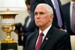 Vice President Mike Pence listens to a reporter's question during a meeting with President Donald Trump and Iraqi Prime Minister Mustafa al-Kadhimi in the Oval Office of the White House, Aug. 20, 2020.