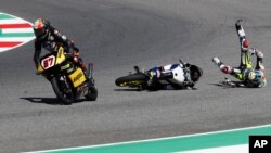 Husqvarna rider Adrian Fernandez, right, crashes during the Moto 3 Grand Prix of Italy at the Mugello circuit in Scarperia, Italy.