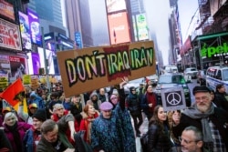 Activists march in Times Square to protest recent U.S. military actions in Iraq, Jan. 4, 2020, in New York.