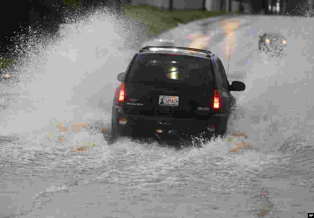 A vehicle passes through deep water following heavy rain.&nbsp;Forecasters declared a tornado emergency in Moore, Oklahoma, May 6, 2015.