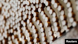 FILE - Cigarettes are seen during the manufacturing process in the British American Tobacco Cigarette Factory (BAT) in Bayreuth, southern Germany, April 30, 2014. 