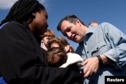 U.S. Republican presidential candidate Ted Cruz greets a woman and her baby at a campaign stop at Altoona Family Restaurant in Altoona, Wisconsin, March 28, 2016.
