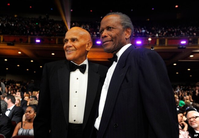 ARCHIVO - Harry Belafonte, izquierda, y Sidney Poitier posan entre la audiencia en la 43a NAACP Image Awards, en Los Ángeles, el 17 de febrero de 2012.