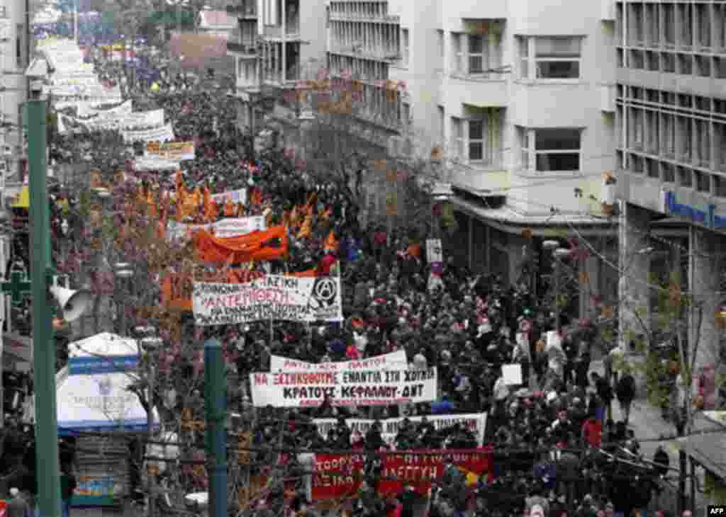 Protesters take part in a rally during a 24-hour strike in Athens, Wednesday, Dec. 15, 2010. Hundreds of protesters clashed with riot police across central Athens, Wednesday, smashing cars and hurling gasoline bombs during a massive labor protest against
