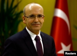 FILE - Turkish Deputy Prime Minister Mehmet Simsek poses during an interview with Reuters in Ankara, Turkey, Dec. 23, 2015.