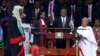 Kenyan President Uhuru Kenyatta, center, is sworn in as his wife, Margaret, right, looks on during his inauguration at Kasarani Stadium in Nairobi, Kenya, Nov. 28, 2017. 