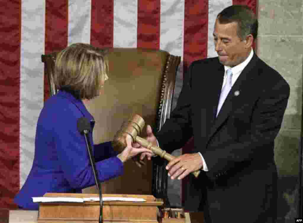 Outgoing House Speaker Nancy Pelosi of Calif. hands the gavel to the new House Speaker John Boehner of Ohio during the first session of the 112th Congress, Wednesday, Jan. 5, 2011, on Capitol Hill in Washington. (AP Photo/Charles Dharapak)
