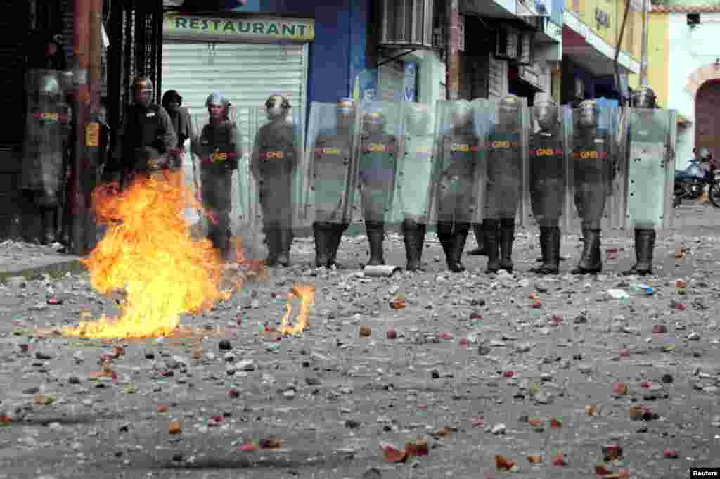 Security forces look on while clashing with opposition supporters participating in a rally against Venezuelan President Nicolas Maduro's government and to commemorate the 61st anniversary of the end of the dictatorship of Marcos Perez Jimenez, in Tachira, Jan. 23, 2019.