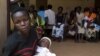 Women queue with their babies to be tested for HIV at a hospital in Bududa, eastern Uganda, on September 27, 2011.