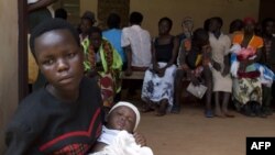 Women queue with their babies to be tested for HIV at a hospital in Bududa, eastern Uganda, September 27, 2011.