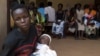 Women wait with their babies to be tested for HIV at a hospital in Bududa, eastern Uganda, September 27, 2011. 