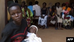 Women wait with their babies to be tested for HIV at a hospital in Bududa, eastern Uganda, September 27, 2011. 