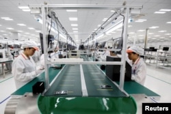 Manufacturers work at an assembly line of Vingroup's Vsmart phone in Hai Phong, Vietnam, Dec. 4, 2018.