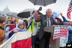 FILE - Democratic presidential candidate Sen. Bernie Sanders joins low-wage workers, some who cook and clean at the U.S. Capitol, at a rally to protest what they describe as poverty pay, Capitol Hill, Washington, Nov. 10, 2015.