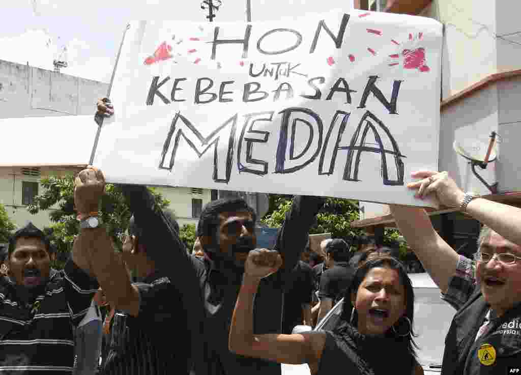 Members of the press hold placards during a rally to mark World Press Freedom Day in Kuala Lumpur, Malaysia, May 3, 2012.