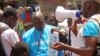 FILE - UNICEF health workers teach people about the Ebola virus and how to prevent infection, in Conakry, Guinea, March 31, 2014..