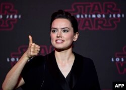 British actress, Daisy Ridley, who plays Rey in "Star Wars: The Last Jedi" gives her thumb up during a press conference to promote the film in Mexico City on Nov. 21, 2017.