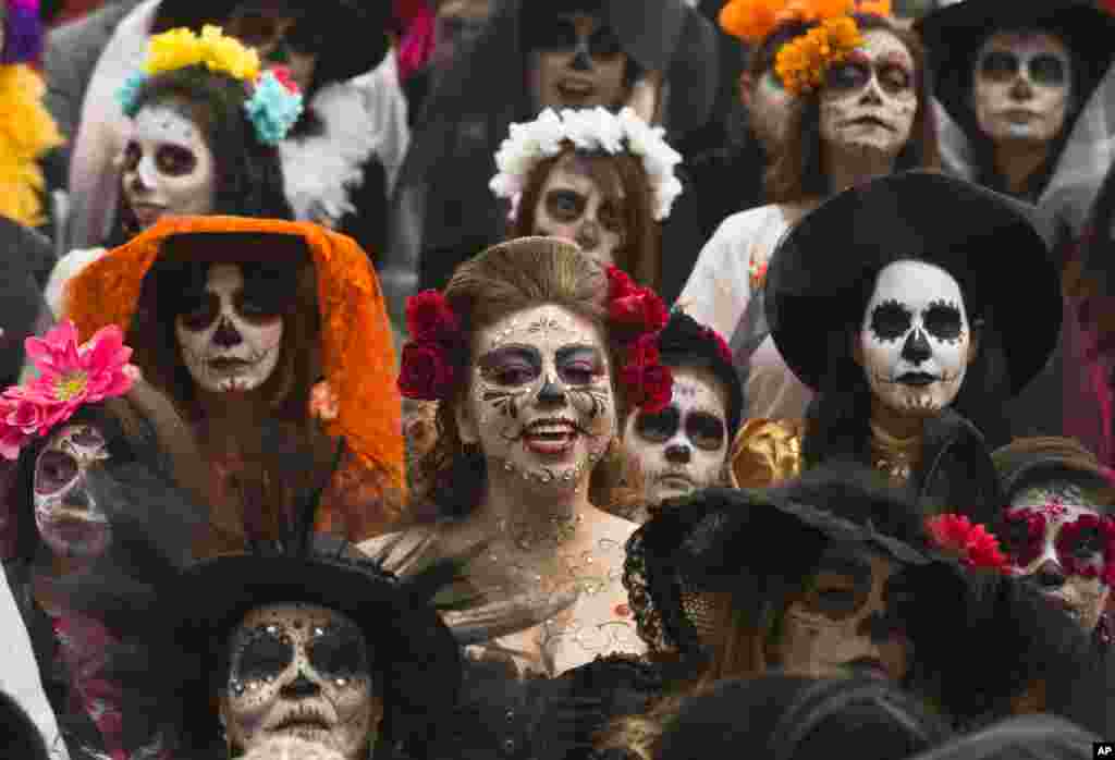 People dressed as &quot;Catrinas&quot; gather to commemorate Day of the Dead, a holiday that honors the deceased, during a Catrina Fest in Mexico City, Nov. 1, 2015.
